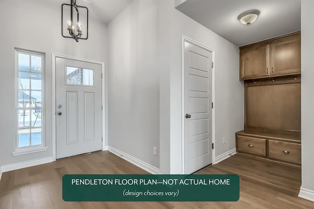 foyer entrance featuring hardwood / wood-style floors and a chandelier