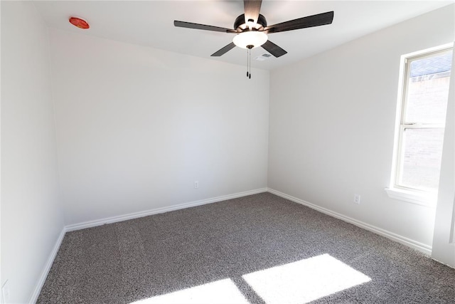 carpeted empty room featuring ceiling fan and a healthy amount of sunlight