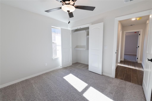 unfurnished bedroom with carpet floors, a closet, and ceiling fan