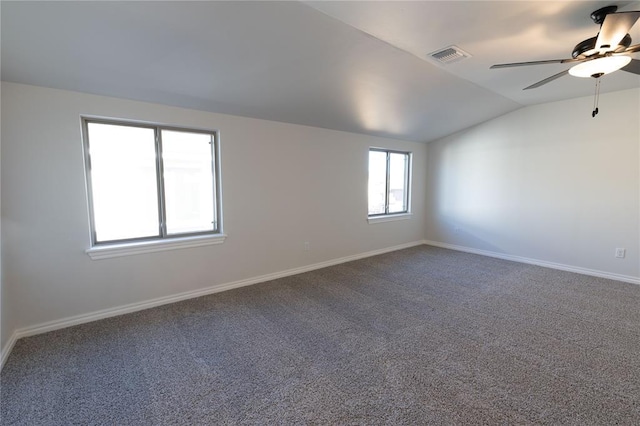 carpeted spare room with ceiling fan and lofted ceiling