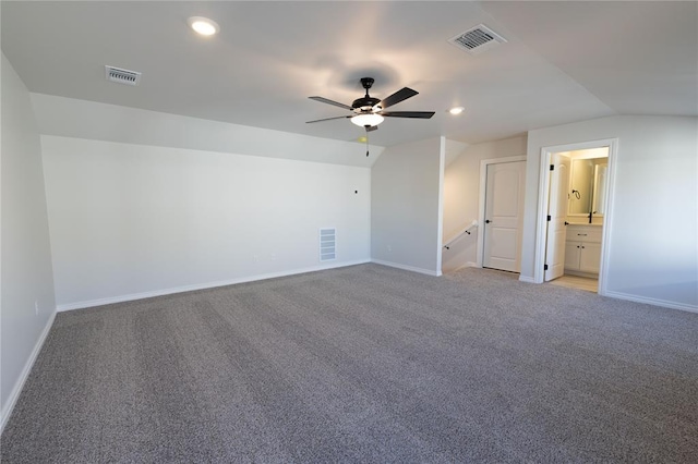 carpeted empty room with ceiling fan and vaulted ceiling