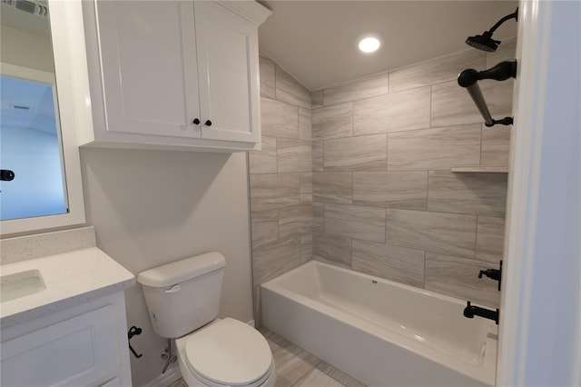 full bathroom featuring vanity, toilet, and tiled shower / bath