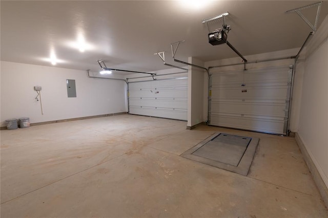 garage with a garage door opener and electric panel