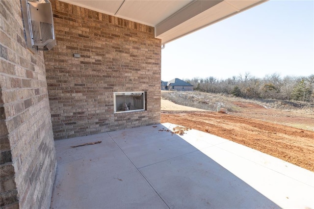 view of patio with a wall unit AC