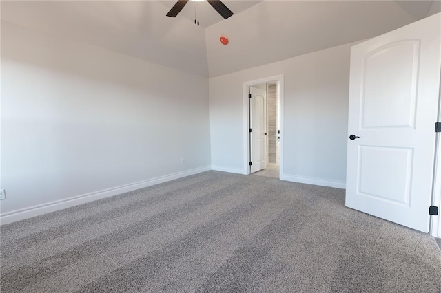 carpeted empty room featuring ceiling fan and vaulted ceiling