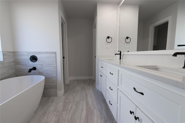 bathroom with vanity and a tub to relax in