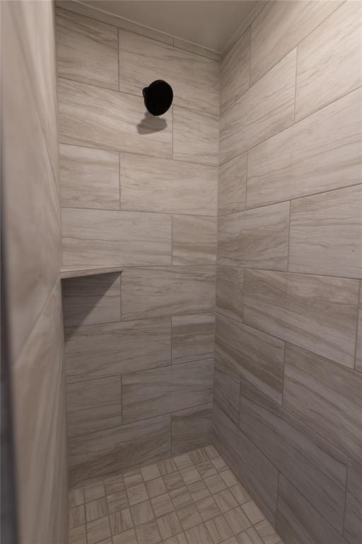 bathroom with a tile shower