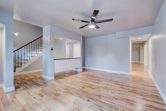 unfurnished living room featuring ceiling fan and light hardwood / wood-style flooring