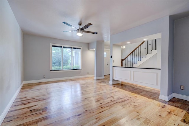 spare room with light wood-type flooring and ceiling fan