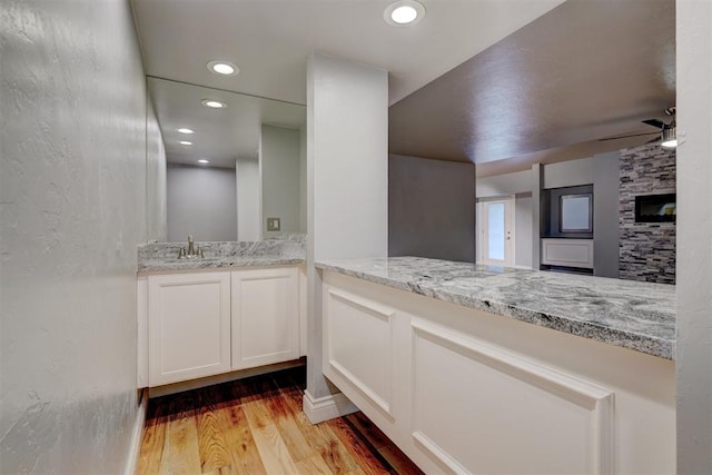 bathroom with ceiling fan, vanity, and hardwood / wood-style flooring