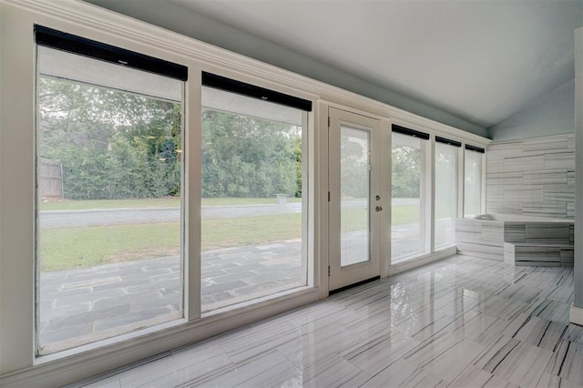 doorway featuring plenty of natural light and lofted ceiling