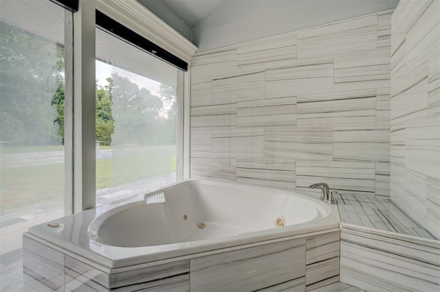 bathroom featuring a relaxing tiled tub