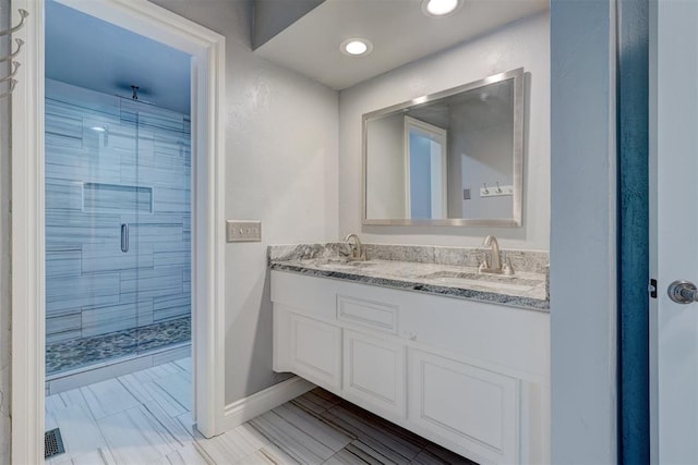 bathroom featuring vanity and a shower with shower door