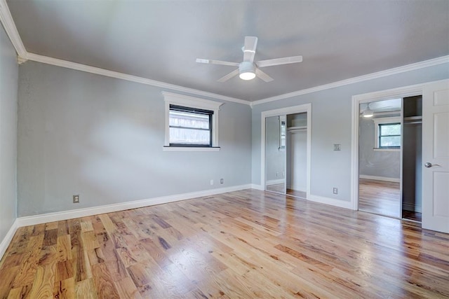 unfurnished bedroom with ceiling fan, light hardwood / wood-style floors, ornamental molding, and multiple windows