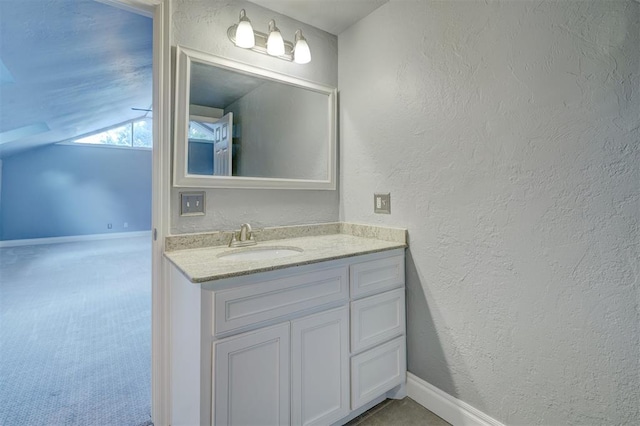 bathroom featuring vanity and vaulted ceiling