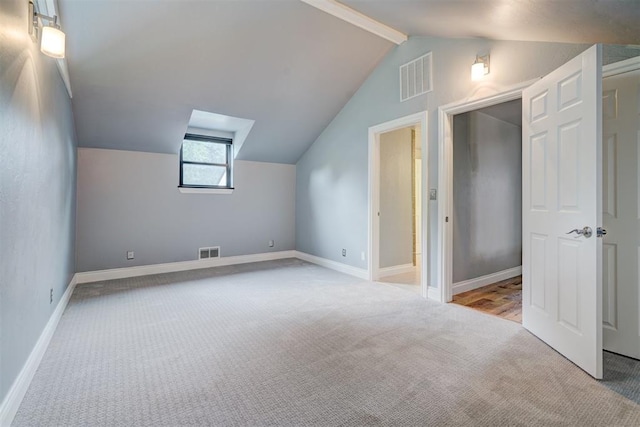 additional living space with light colored carpet and lofted ceiling