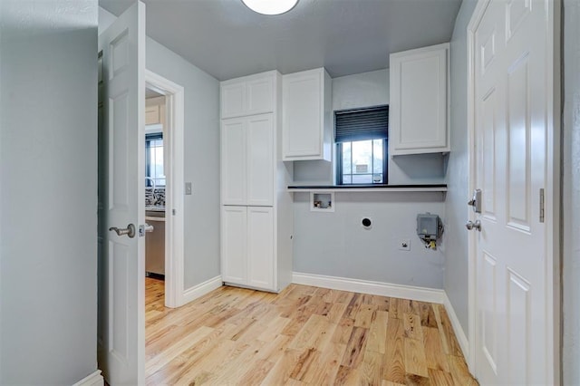 laundry area with cabinets, electric dryer hookup, hookup for a gas dryer, hookup for a washing machine, and light hardwood / wood-style floors