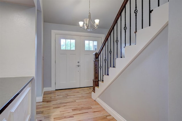 foyer featuring a chandelier and light hardwood / wood-style flooring