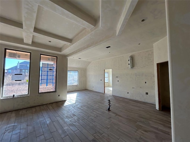 spare room with beamed ceiling, coffered ceiling, and hardwood / wood-style floors