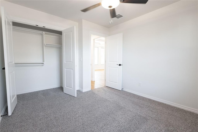 unfurnished bedroom with carpet, ceiling fan, and a closet