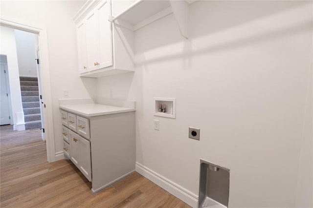 laundry room featuring cabinets, hookup for a washing machine, hookup for an electric dryer, and light hardwood / wood-style floors