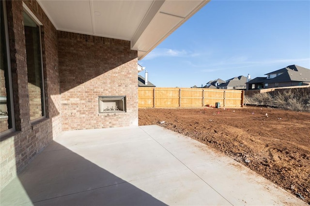 view of patio with an outdoor brick fireplace