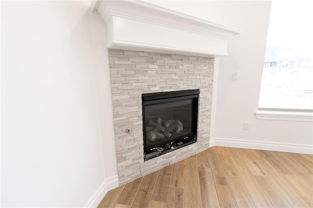 interior details featuring wood-type flooring and a fireplace