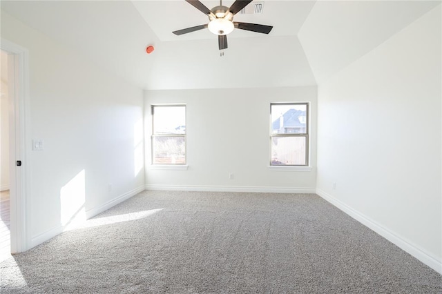 carpeted empty room featuring lofted ceiling, plenty of natural light, and ceiling fan