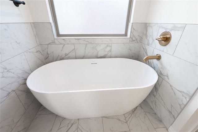 bathroom featuring a tub and a wealth of natural light