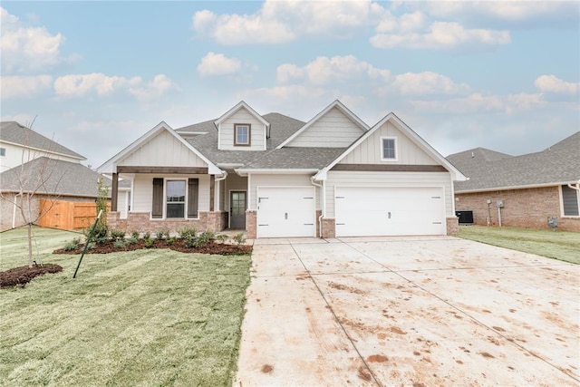 view of front of home with concrete driveway, an attached garage, a front yard, board and batten siding, and brick siding