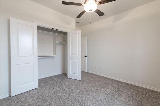 unfurnished bedroom with a closet, carpet flooring, visible vents, and baseboards