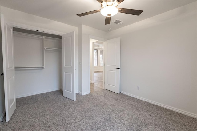 unfurnished bedroom with carpet floors, a closet, visible vents, ceiling fan, and baseboards