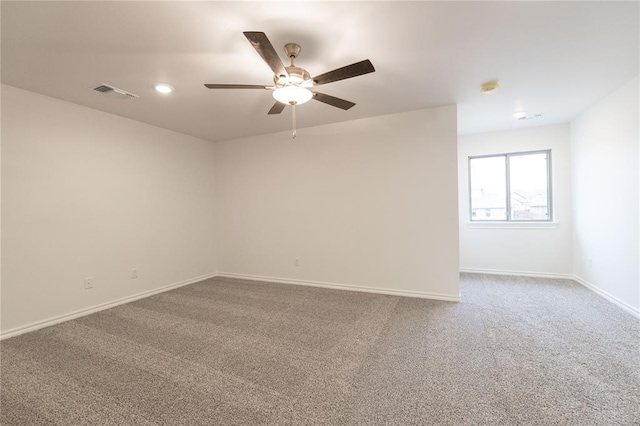 unfurnished room featuring recessed lighting, carpet floors, a ceiling fan, visible vents, and baseboards