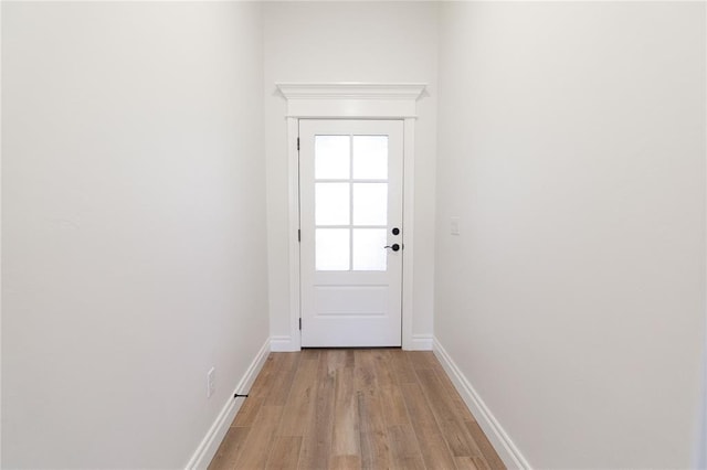 entryway featuring baseboards and light wood finished floors