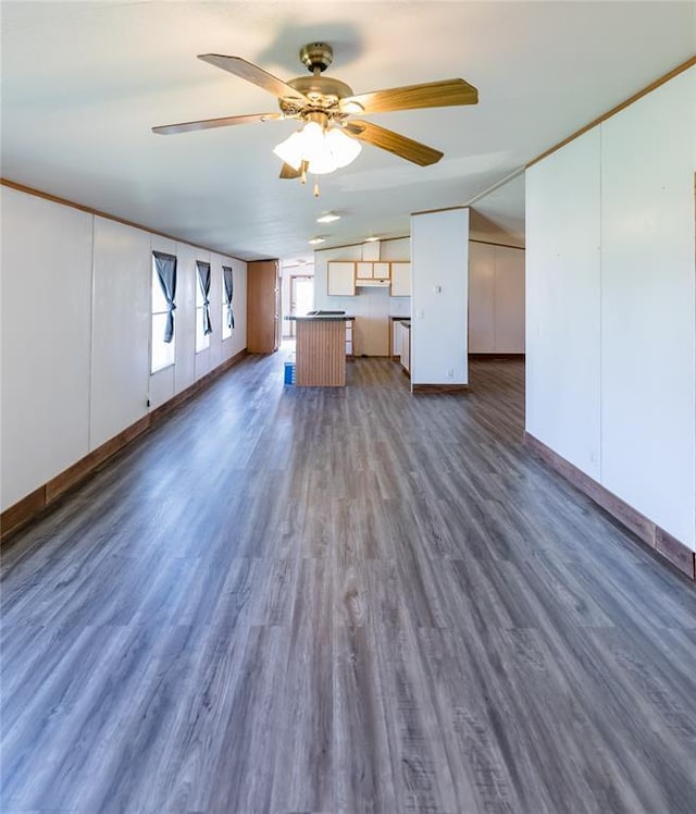 306 E Ninth St, Leedey, OK 73654 - unfurnished living room featuring vaulted ceiling, a ceiling fan, and dark wood finished floors