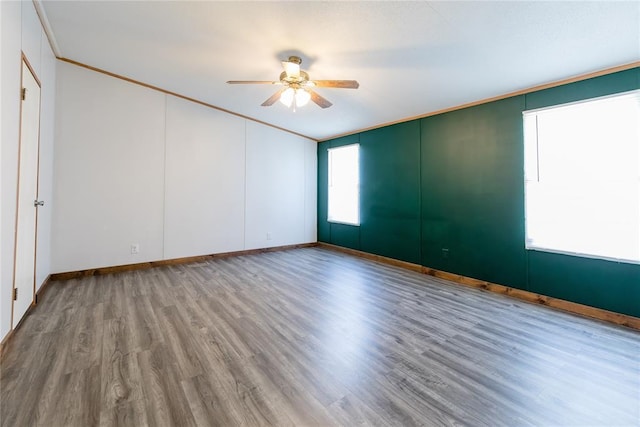 306 E Ninth St, Leedey, OK 73654 - empty room with a ceiling fan, wood finished floors, and crown molding