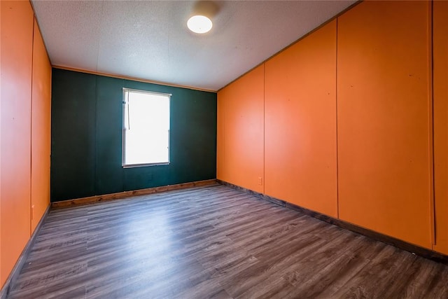 306 E Ninth St, Leedey, OK 73654 - empty room featuring dark wood-style flooring and a textured ceiling