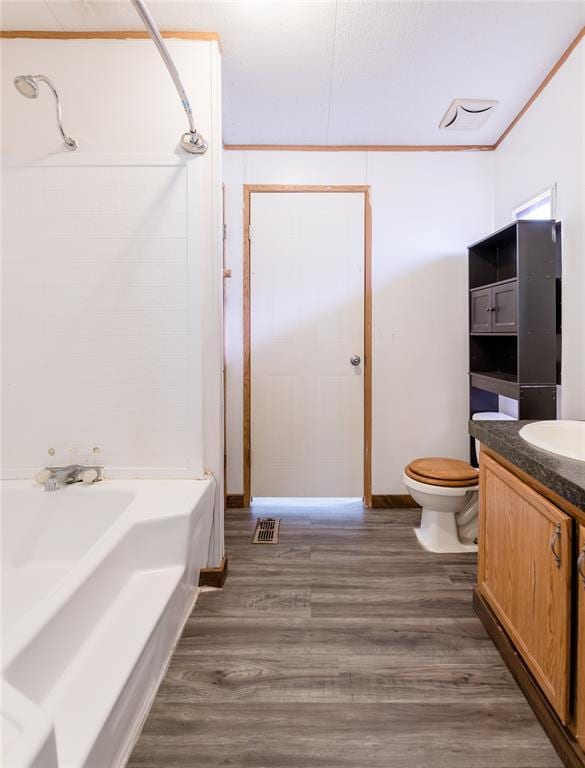 306 E Ninth St, Leedey, OK 73654 - full bath featuring vanity, wood finished floors, washtub / shower combination, and crown molding