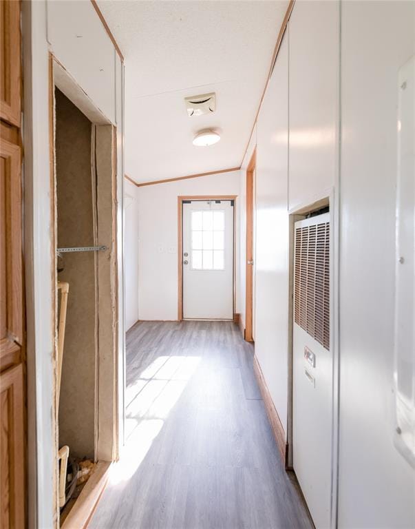 306 E Ninth St, Leedey, OK 73654 - hallway with a heating unit and wood finished floors