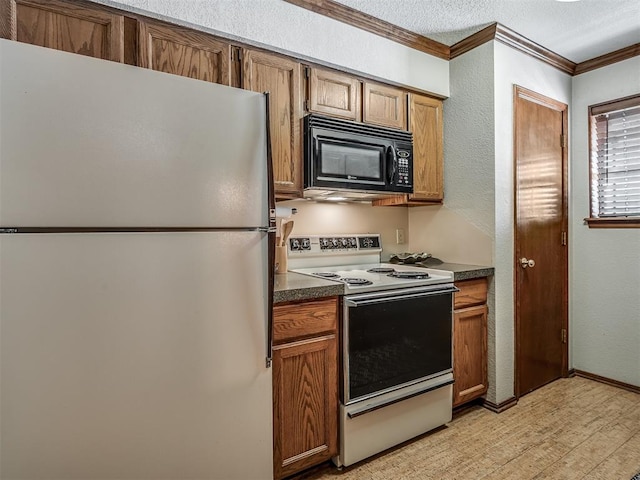 kitchen with a textured ceiling, light hardwood / wood-style floors, white appliances, and ornamental molding