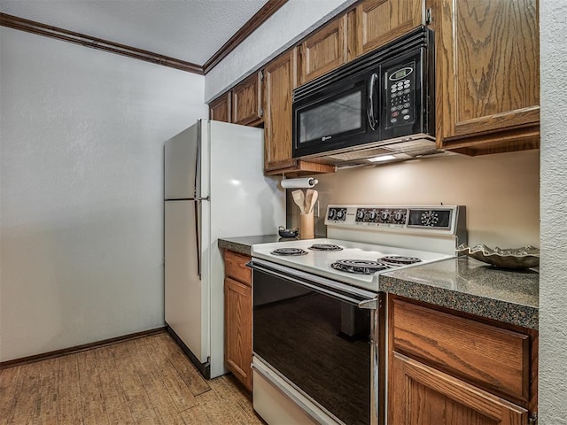 kitchen with a textured ceiling, light wood-type flooring, white appliances, and crown molding