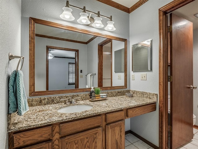 bathroom with tile patterned flooring, vanity, toilet, and crown molding