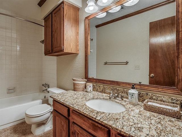 full bathroom featuring vanity, toilet, tiled shower / bath, and ornamental molding