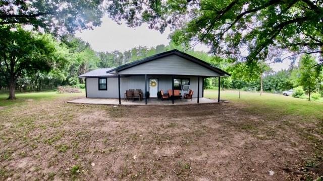 rear view of property featuring a patio area