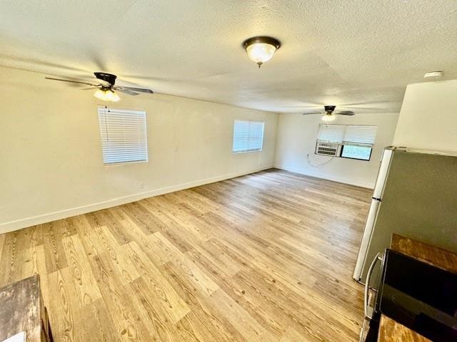 interior space with light wood-type flooring and a textured ceiling