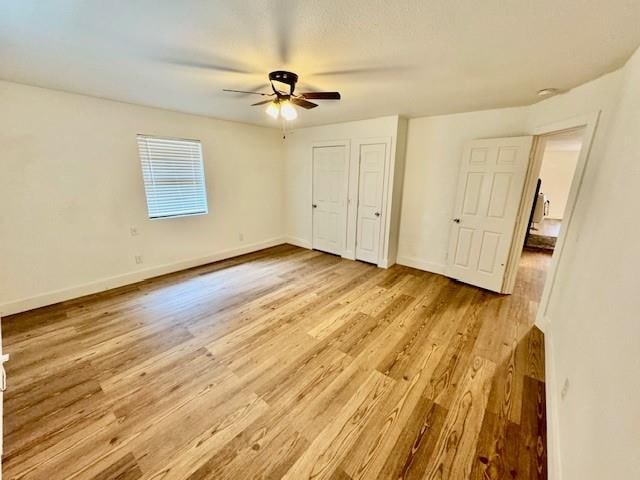 unfurnished bedroom featuring light hardwood / wood-style floors and ceiling fan