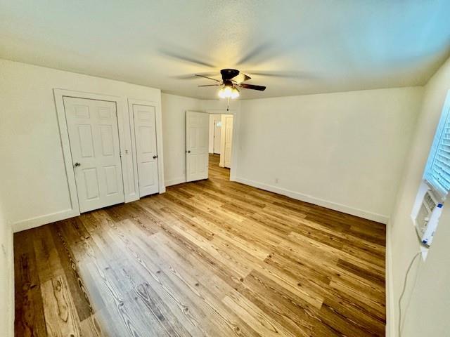 unfurnished bedroom featuring ceiling fan and light hardwood / wood-style floors