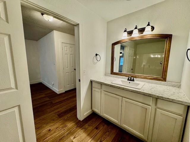 bathroom with vanity and hardwood / wood-style flooring