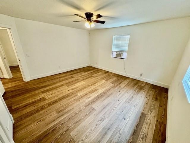 unfurnished room with a wealth of natural light and hardwood / wood-style flooring