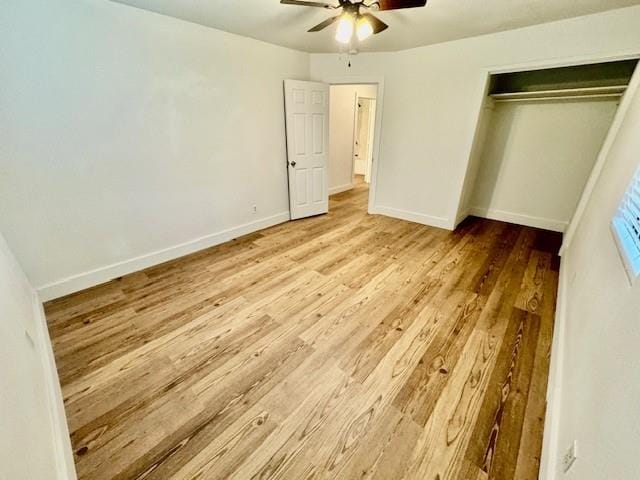 unfurnished bedroom featuring a closet, light hardwood / wood-style floors, and ceiling fan